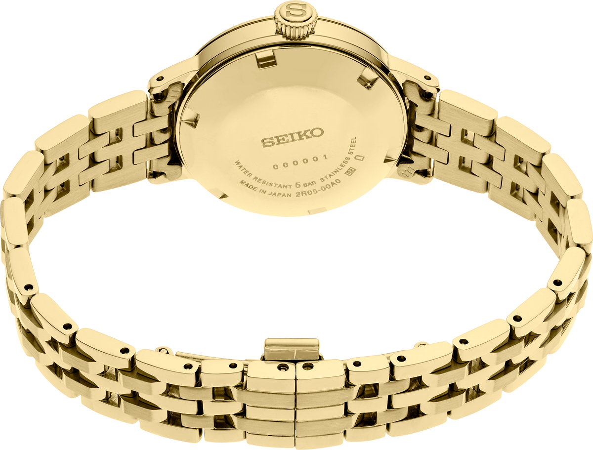Close view of the Seiko SRE018 Eggnog gold dial showing pressed sunburst pattern and four diamond hour markers